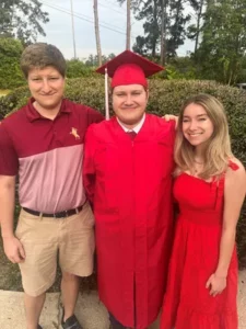 Joey Williams with his brother and sister at his high school graduation. Photo Provided by Olga Williams